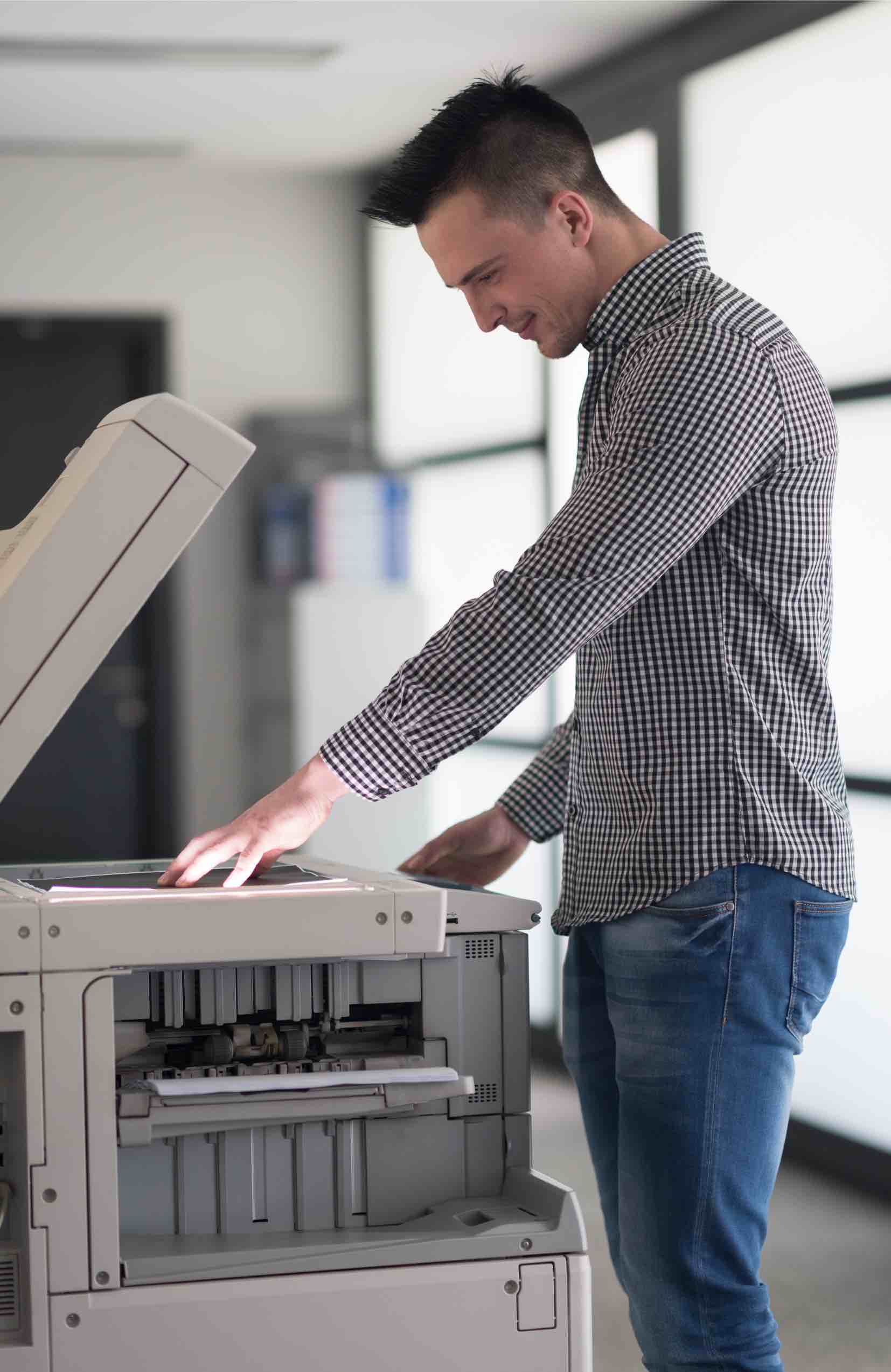 This man scans documents to get his small business go paperless thanks to tips from Paramount Tax & Accounting CPAs - Rancho Cucamonga.